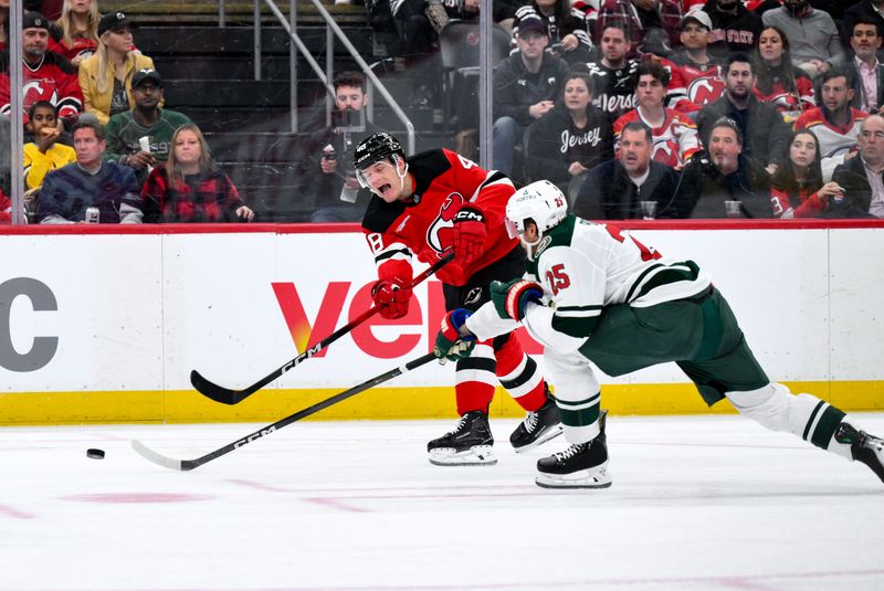 Oct 22, 2025; Newark, New Jersey, USA; New Jersey Devils left wing Brian Halonen (48) takes a shot on goal as Minnesota Wild defenseman Jonas Brodin (25) defends during the second period at Prudential Center. Mandatory Credit: John Jones-Imagn Images