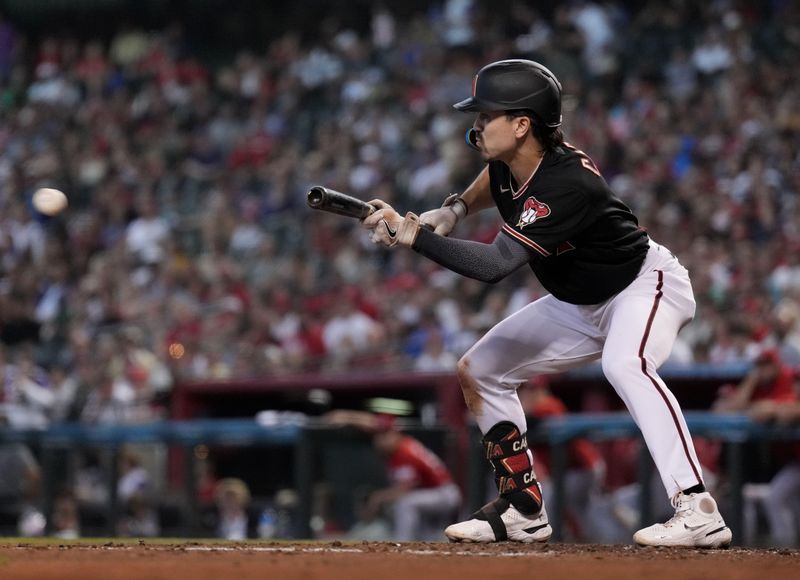 Aug 26, 2023; Phoenix, Arizona, USA; Arizona Diamondbacks right fielder Corbin Carroll (7) bunts against the Cincinnati Reds during the third inning at Chase Field. Mandatory Credit: Joe Camporeale-USA TODAY Sports