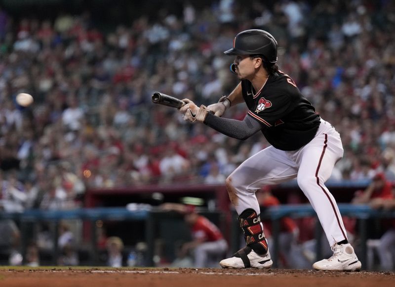 Aug 26, 2023; Phoenix, Arizona, USA; Arizona Diamondbacks right fielder Corbin Carroll (7) bunts against the Cincinnati Reds during the third inning at Chase Field. Mandatory Credit: Joe Camporeale-USA TODAY Sports