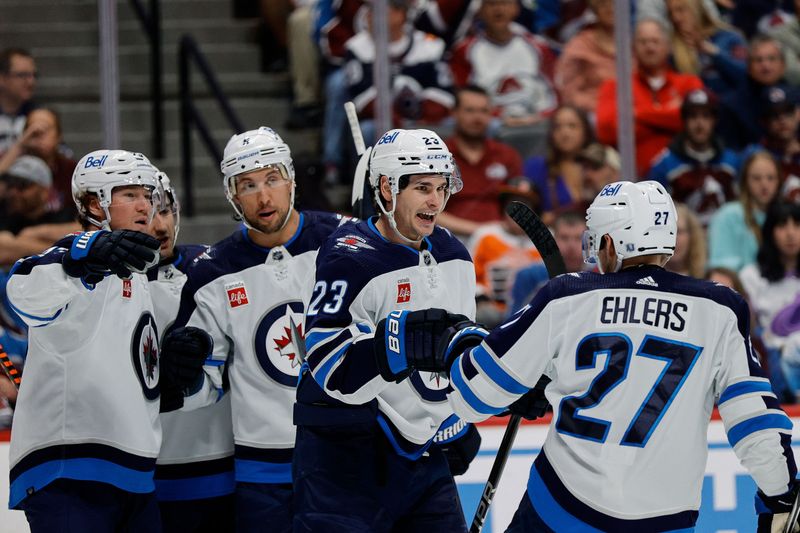 Apr 13, 2024; Denver, Colorado, USA; Winnipeg Jets center Sean Monahan (23) celebrates his goal with left wing Nikolaj Ehlers (27) in the first period against the Colorado Avalanche at Ball Arena. Mandatory Credit: Isaiah J. Downing-USA TODAY Sports