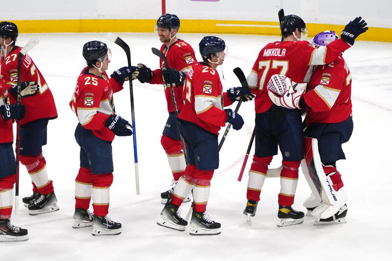 Nov 16, 2024; Sunrise, Florida, USA;  Florida Panthers defenseman Niko Mikkola (77) congratulates goaltender Sergei Bobrovsky (72) following a victory over the Winnipeg Jets at Amerant Bank Arena. Mandatory Credit: Jim Rassol-Imagn Images