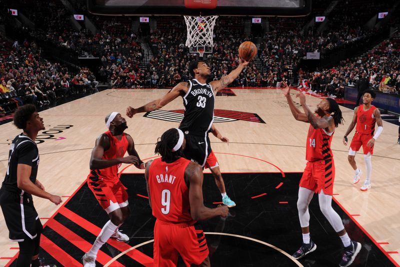 PORTLAND, OR - JANUARY 17: Nicolas Claxton #33 of the Brooklyn Nets rebounds the ball during the game against the Portland Trail Blazers on January 17, 2024 at the Moda Center Arena in Portland, Oregon. NOTE TO USER: User expressly acknowledges and agrees that, by downloading and or using this photograph, user is consenting to the terms and conditions of the Getty Images License Agreement. Mandatory Copyright Notice: Copyright 2024 NBAE (Photo by Cameron Browne/NBAE via Getty Images)