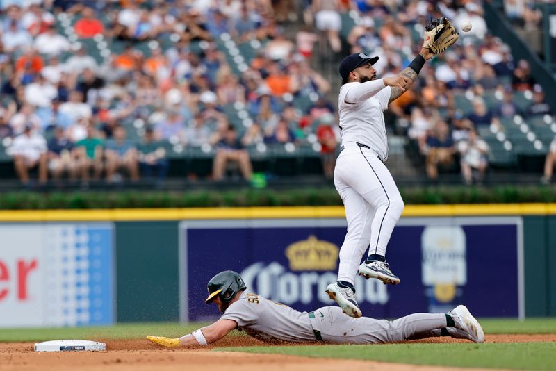 Jun 26, 2025; Detroit, Michigan, USA;  Athletics third base Max Schuemann (12) steals second ahead of the throw to Detroit Tigers second base Gleyber Torres (25) in the third inning at Comerica Park. Mandatory Credit: Rick Osentoski-Imagn Images