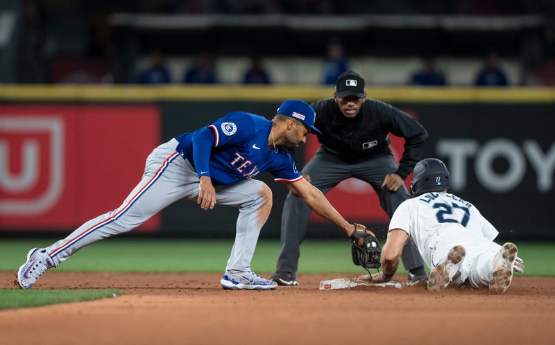 Jun 15, 2024; Seattle, Washington, USA; Seattle Mariners first baseman Tyler Locklear (20) steals second base ahead of a tag by Texas Rangers second baseman Marcus Semien (2) during the sixth inning at T-Mobile Park. Mandatory Credit: Stephen Brashear-USA TODAY Sports