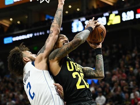 SALT LAKE CITY, UTAH - JANUARY 01: John Collins #20 of the Utah Jazz shoots over Dereck Lively II #2 of the Dallas Mavericks during the first half of a game at Delta Center on January 01, 2024 in Salt Lake City, Utah. NOTE TO USER: User expressly acknowledges and agrees that, by downloading and or using this photograph, User is consenting to the terms and conditions of the Getty Images License Agreement. (Photo by Alex Goodlett/Getty Images)