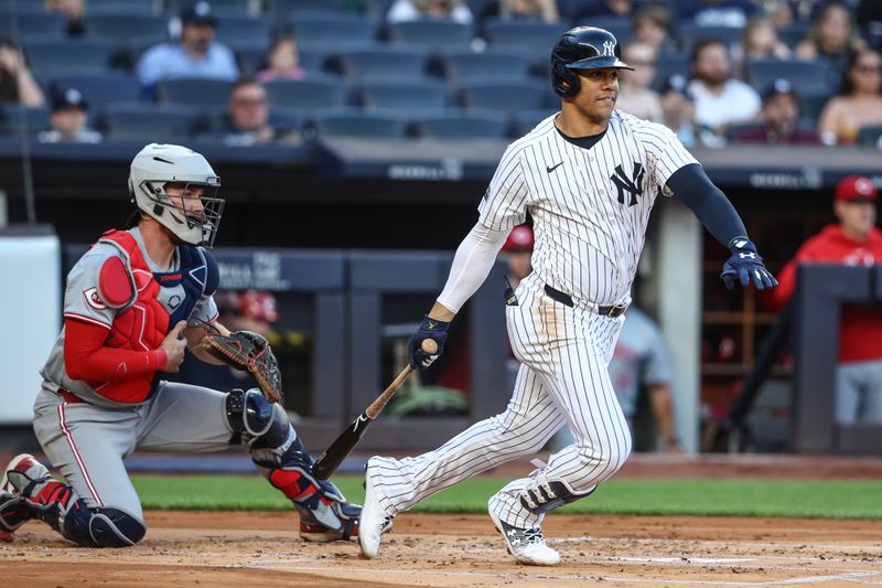 Jul 3, 2024; Bronx, New York, USA; New York Yankees right fielder Juan Soto (22) hits a single in the first inning against the Cincinnati Reds at Yankee Stadium. Mandatory Credit: Wendell Cruz-USA TODAY Sports