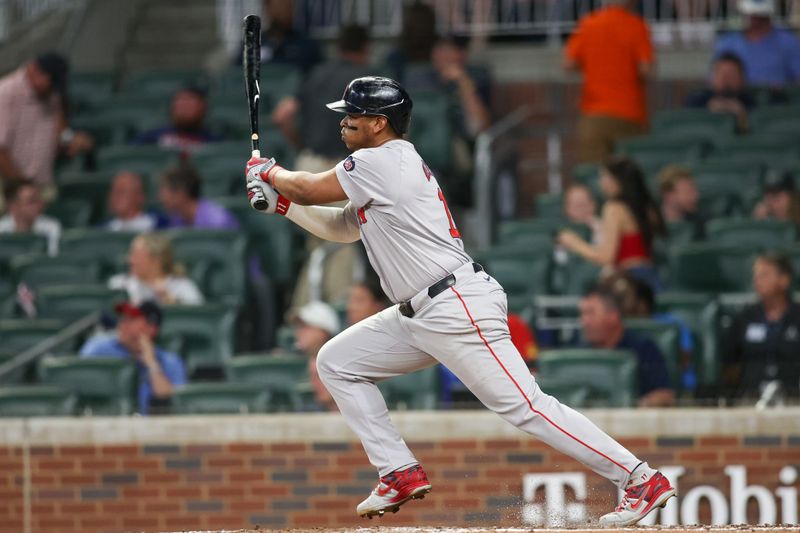 May 8, 2024; Atlanta, Georgia, USA; Boston Red Sox third baseman Rafael Devers (11) hits a single against the Atlanta Braves in the eighth inning at Truist Park. Mandatory Credit: Brett Davis-USA TODAY Sports