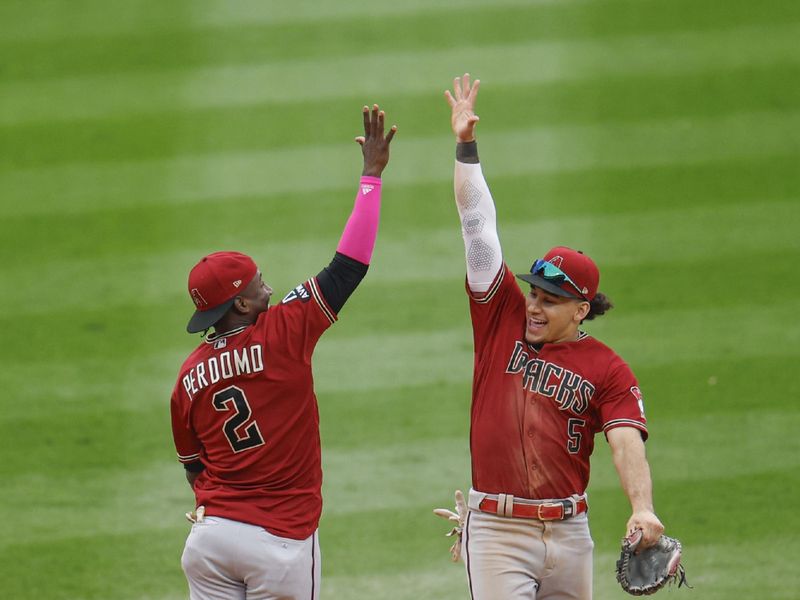 Sep 27, 2023; Chicago, Illinois, USA; Arizona Diamondbacks shortstop Geraldo Perdomo (2) and center fielder Alek Thomas (5) celebrate the teams win against the Chicago White Sox at Guaranteed Rate Field. Mandatory Credit: Kamil Krzaczynski-USA TODAY Sports