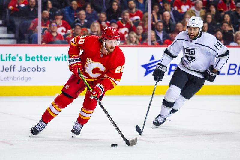 Mar 28, 2023; Calgary, Alberta, CAN; Calgary Flames center Blake Coleman (20) skates with the puck in front of Los Angeles Kings left wing Alex Iafallo (19) during the first period at Scotiabank Saddledome. Mandatory Credit: Sergei Belski-USA TODAY Sports