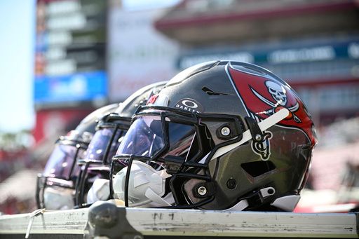 Tampa Bay Buccaneers helmets are viewed on the sideline before an NFL football game against the Las Vegas Raiders, Sunday, Dec. 8, 2024, in Tampa, Fla. (AP Photo/Phelan M. Ebenhack)