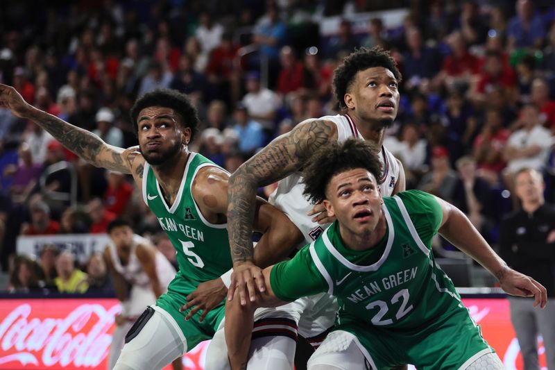 Jan 28, 2024; Boca Raton, Florida, USA; Florida Atlantic Owls guard Alijah Martin (15) looks on during a free-throw attempt as North Texas Mean Green guard CJ Noland (22) and guard Rondel Walker (5) defend during the second half at Eleanor R. Baldwin Arena. Mandatory Credit: Sam Navarro-USA TODAY Sports