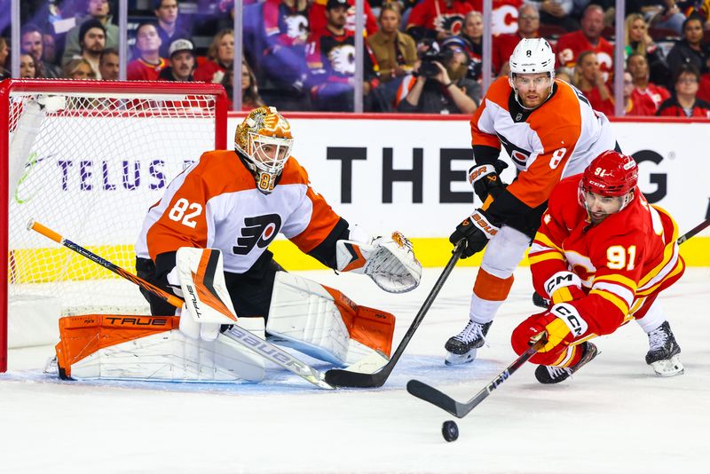 Oct 12, 2024; Calgary, Alberta, CAN; Calgary Flames center Nazem Kadri (91) controls the puck in front of Philadelphia Flyers goaltender Ivan Fedotov (82) during the second period at Scotiabank Saddledome. Mandatory Credit: Sergei Belski-Imagn Images