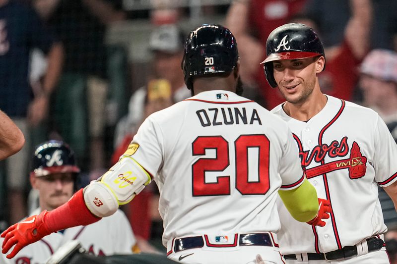 Aug 23, 2023; Cumberland, Georgia, USA; Atlanta Braves designated hitter Marcell Ozuna (20) reacts with first baseman Matt Olson (28)  after hitting a two run home run against the New York Mets during the seventh inning at Truist Park. Mandatory Credit: Dale Zanine-USA TODAY Sports