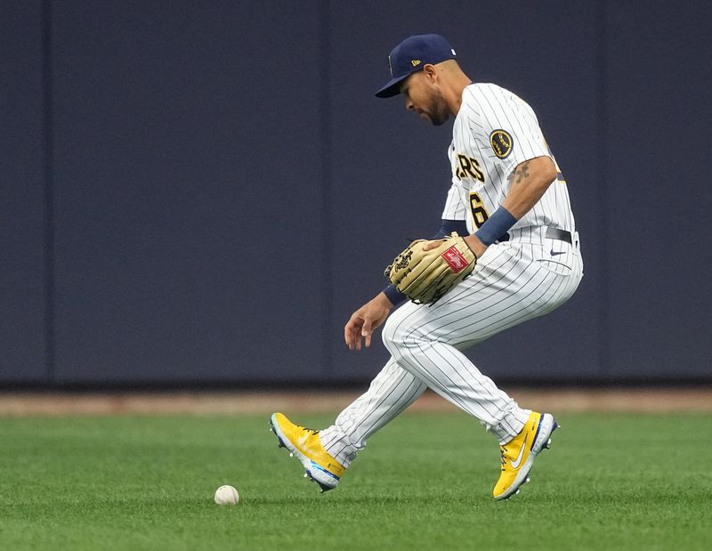 Apr 23, 2023; Milwaukee, Wisconsin, USA; Milwaukee Brewers center fielder Blake Perkins (16) commits a fielding error during the first inning of their game against the Boston Red Sox at American Family Field. Mandatory Credit: Mark Hoffman-USA TODAY Sports