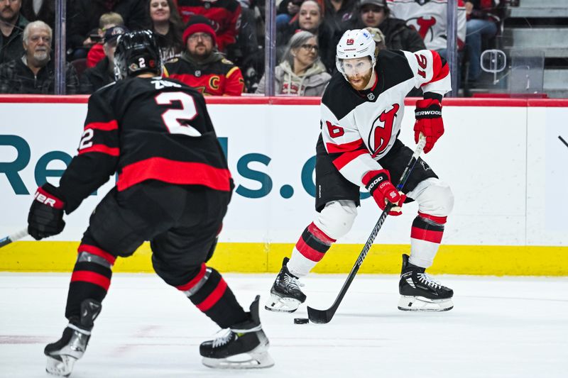 Jan 31, 2026; Ottawa, Ontario, CAN; New Jersey Devils right wing Connor Brown (16) plays the puck against Ottawa Senators defenseman Artem Zub (2) during the second period at Canadian Tire Centre. Mandatory Credit: David Kirouac-Imagn Images