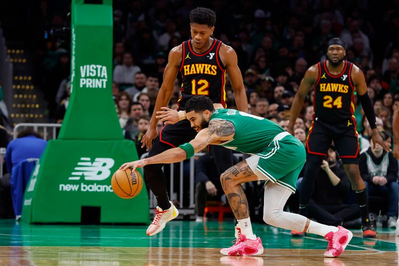 BOSTON, MA - FEBRUARY 7: Jayson Tatum #0 of the Boston Celtics grabs a loose ball against De'Andre Hunter #12 of the Atlanta Hawks during the second quarter at TD Garden on February 7, 2024 in Boston, Massachusetts. NOTE TO USER: User expressly acknowledges and agrees that, by downloading and/or using this Photograph, user is consenting to the terms and conditions of the Getty Images License Agreement. (Photo By Winslow Townson/Getty Images)