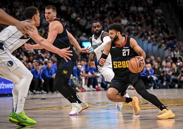 DENVER, CO - DECEMBER 18: Jamal Murray (27) of the Denver Nuggets dribbles as Nikola Jokic (15) rolls around Dwight Powell (7) of the Dallas Mavericks during the first quarter at Ball Arena in Denver on Monday, December 18, 2023. (Photo by AAron Ontiveroz/The Denver Post)