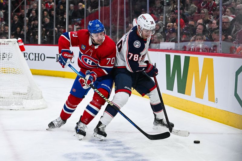 Mar 12, 2024; Montreal, Quebec, CAN; Columbus Blue Jackets defenseman Damon Severson (78) defends the puck against Montreal Canadiens left wing Tanner Pearson (70) during the first period at Bell Centre. Mandatory Credit: David Kirouac-USA TODAY Sports