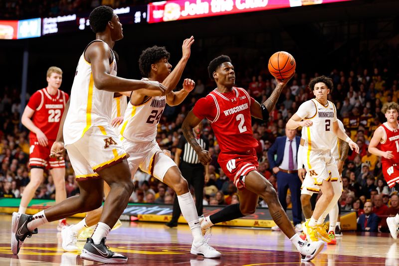 Jan 23, 2024; Minneapolis, Minnesota, USA; Wisconsin Badgers guard AJ Storr (2) drives towards the basket as Minnesota Golden Gophers guard Cam Christie (24) defends during the second half at Williams Arena. Mandatory Credit: Matt Krohn-USA TODAY Sports