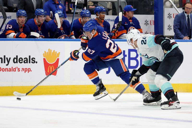 Dec 5, 2024; Elmont, New York, USA; New York Islanders left wing Anders Lee (27) skates with the puck against Seattle Kraken defenseman Jamie Oleksiak (24) during the second period at UBS Arena. Mandatory Credit: Brad Penner-Imagn Images