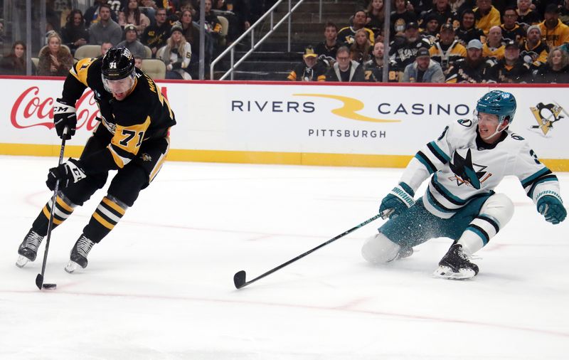 Nov 16, 2024; Pittsburgh, Pennsylvania, USA;  Pittsburgh Penguins center Evgeni Malkin (71) moves the puck against San Jose Sharks defenseman Henry Thrun (3) during the first period at PPG Paints Arena. Mandatory Credit: Charles LeClaire-Imagn Images