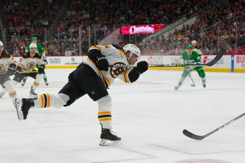 Mar 26, 2023; Raleigh, North Carolina, USA;  Boston Bruins center Jakub Lauko (94) scores a goal on his shot against the Carolina Hurricanes during the second period at PNC Arena. Mandatory Credit: James Guillory-USA TODAY Sports