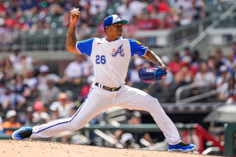 Jul 30, 2023; Cumberland, Georgia, USA; Atlanta Braves relief pitcher Raisel Iglesias (26) pitches against the Milwaukee Brewers during the ninth inning at Truist Park. Mandatory Credit: Dale Zanine-USA TODAY Sports