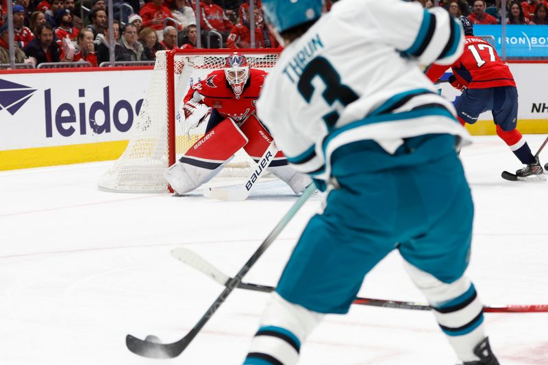 Dec 3, 2024; Washington, District of Columbia, USA; Washington Capitals goaltender Logan Thompson (48) prepares to make a save on San Jose Sharks defenseman Henry Thrun (3) in the second period at Capital One Arena. Mandatory Credit: Geoff Burke-Imagn Images