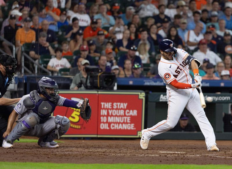 Jul 5, 2023; Houston, Texas, USA; Houston Astros catcher Yainer Diaz (21) hits a two run home run against the Colorado Rockies in the fourth inning at Minute Maid Park. Mandatory Credit: Thomas Shea-USA TODAY Sports