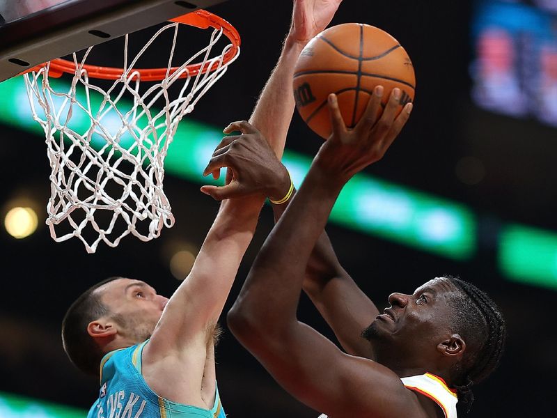 ATLANTA, GEORGIA - MARCH 23:  Clint Capela #15 of the Atlanta Hawks attacks the basket against Aleksej Pokusevski #17 of the Charlotte Hornets during the second quarter at State Farm Arena on March 23, 2024 in Atlanta, Georgia.  NOTE TO USER: User expressly acknowledges and agrees that, by downloading and/or using this photograph, user is consenting to the terms and conditions of the Getty Images License Agreement.  (Photo by Kevin C. Cox/Getty Images)