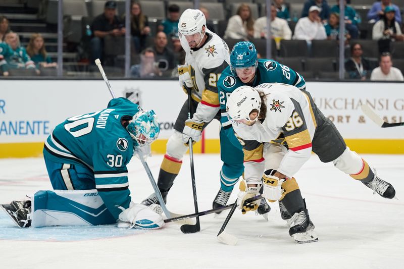 Sep 26, 2025; San Jose, California, USA; San Jose Sharks goaltender Yaroslav Askarov (30) and defenseman Jack Thompson (26) defend the puck against Vegas Golden Knights center Raphael Lavoie (36) and center Matyas Sapovaliv (25) during the first period at SAP Center at San Jose. Mandatory Credit: Robert Edwards-Imagn Images