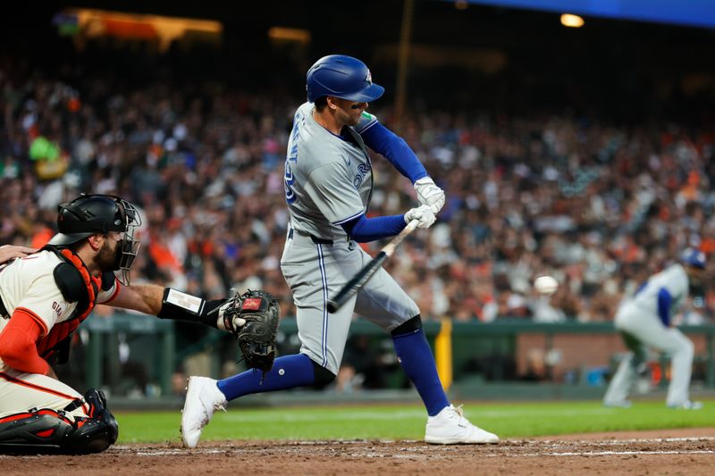 Jul 10, 2024; San Francisco, California, USA; Toronto Blue Jays third baseman Ernie Clement (28) hits a RBI single during the sixth inning against the San Francisco Giants at Oracle Park. Mandatory Credit: Sergio Estrada-USA TODAY Sports