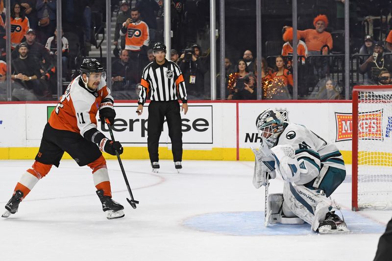 Nov 11, 2024; Philadelphia, Pennsylvania, USA; Philadelphia Flyers right wing Travis Konecny (11) scores the game-winning goal against San Jose Sharks goaltender Vitek Vanecek (41) during the shootout period at Wells Fargo Center. Mandatory Credit: Eric Hartline-Imagn Images