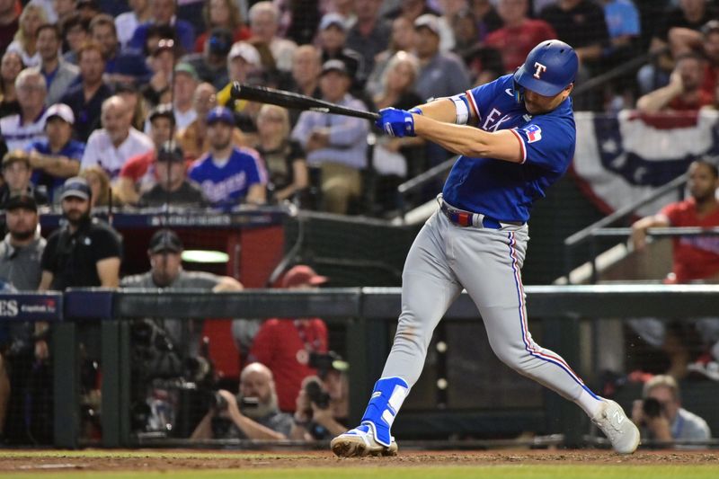 Nov 1, 2023; Phoenix, AZ, USA; Texas Rangers first baseman Nathaniel Lowe (30) hits a single in the ninth inning against the Arizona Diamondbacks in game five of the 2023 World Series at Chase Field. Mandatory Credit: Matt Kartozian-USA TODAY Sports