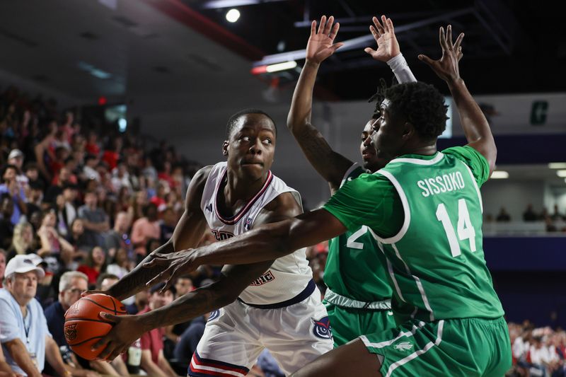 Jan 28, 2024; Boca Raton, Florida, USA; Florida Atlantic Owls guard Johnell Davis (1) protects the basketball from North Texas Mean Green forward Moulaye Sissoko (14) and guard Jason Edwards (2) during the second half at Eleanor R. Baldwin Arena. Mandatory Credit: Sam Navarro-USA TODAY Sports