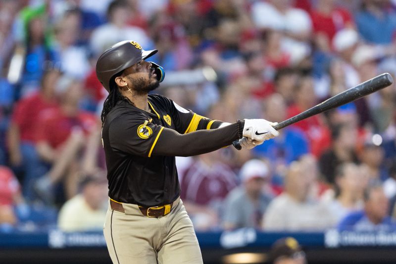 Jun 18, 2024; Philadelphia, Pennsylvania, USA; San Diego Padres catcher Luis Campusano (12) hits a two RBI home run during the sixth inning against the Philadelphia Phillies at Citizens Bank Park. Mandatory Credit: Bill Streicher-USA TODAY Sports
