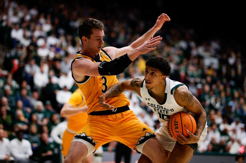 Feb 15, 2025; Fort Collins, Colorado, USA; Colorado State Rams guard Nique Clifford (10) controls the ball under pressure from Wyoming Cowboys forward Cole Henry (8) in the second half at Moby Arena. Mandatory Credit: Isaiah J. Downing-Imagn Images