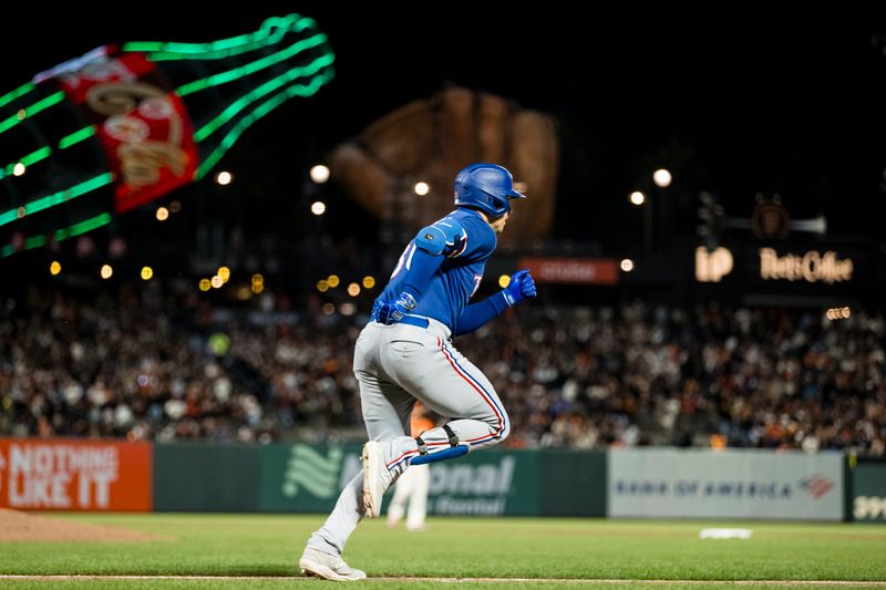 Aug 11, 2023; San Francisco, California, USA; Texas Rangers first baseman Nathaniel Lowe (30) reaches for a single against the San Francisco Giants during the eighth inning at Oracle Park. Mandatory Credit: John Hefti-USA TODAY Sports