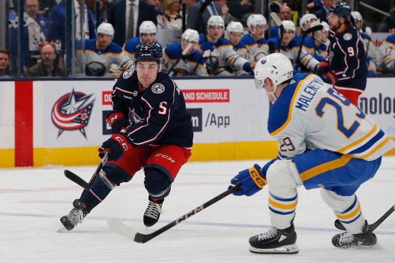 Apr 10, 2025; Columbus, Ohio, USA; Columbus Blue Jackets defenseman Denton Mateychuk (5) passes the puck as Buffalo Sabres left wing Beck Malenstyn (29) defends during the second period at Nationwide Arena. Mandatory Credit: Russell LaBounty-Imagn Images