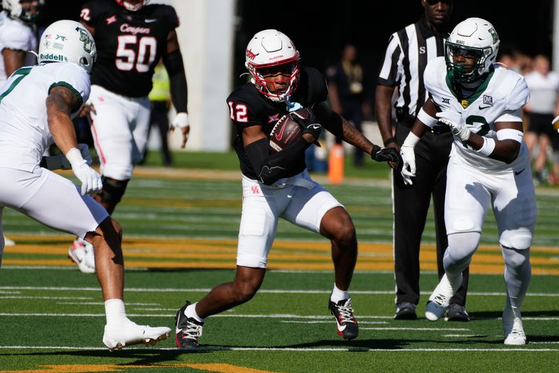 Nov 4, 2023; Waco, Texas, USA;  Houston Cougars wide receiver Stephon Johnson (12) makes a catch between Baylor Bears safety Bryson Jackson (7) and linebacker Jeremy Evans (42) during the first half at McLane Stadium. Mandatory Credit: Chris Jones-USA TODAY Sports