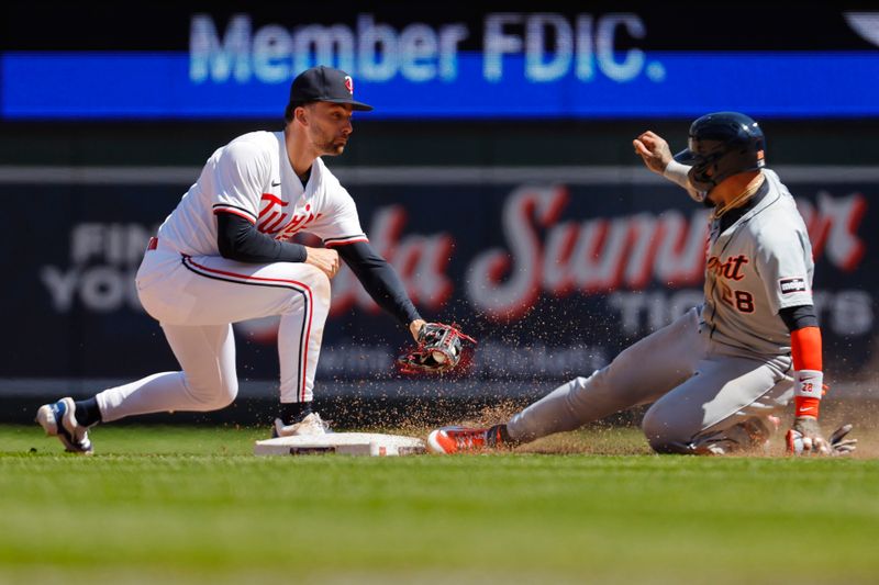 Apr 21, 2024; Minneapolis, Minnesota, USA; Detroit Tigers shortstop Javier Baez (28) tags up from first base and beats the play of Minnesota Twins second baseman Edouard Julien (47) to get to second base in the fourth inning at Target Field. Mandatory Credit: Bruce Kluckhohn-USA TODAY Sports