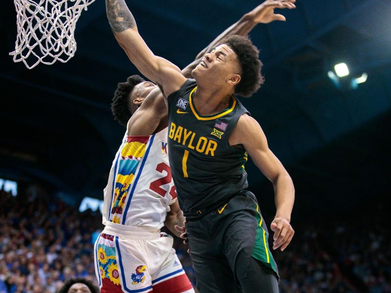 Feb 18, 2023; Lawrence, Kansas, USA; Baylor Bears guard Keyonte George (1) goes up for a dunk in front of Kansas Jayhawks forward K.J. Adams Jr. (24) during the first half at Allen Fieldhouse. Mandatory Credit: William Purnell-USA TODAY Sports