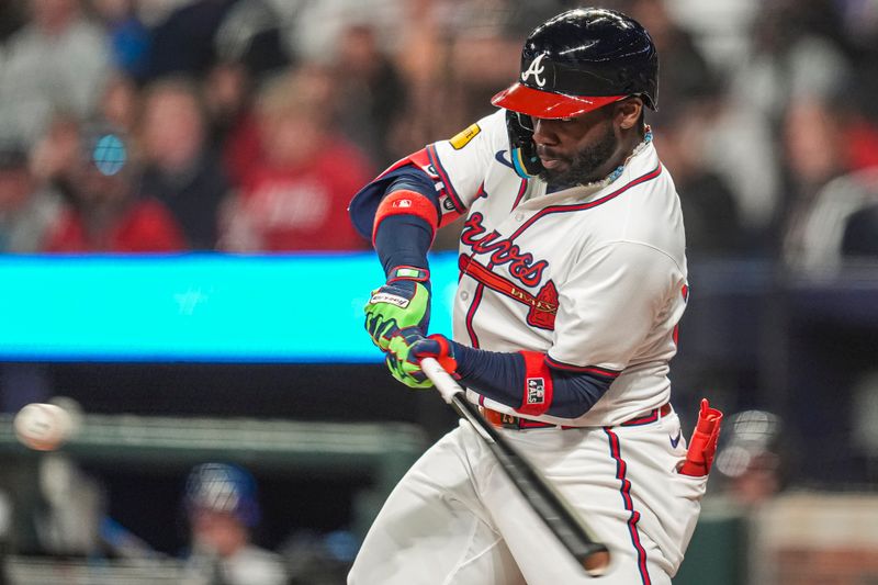 Apr 21, 2024; Cumberland, Georgia, USA; Atlanta Braves center fielder Michael Harris II (23) hits a ball to right field and reaches base on an error against the Texas Rangers during the eighth inning at Truist Park. Mandatory Credit: Dale Zanine-USA TODAY Sports