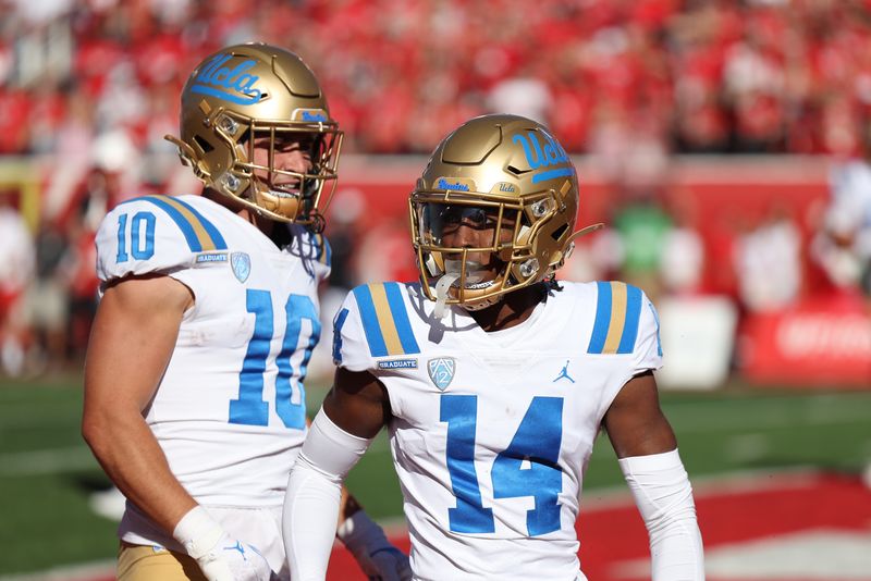 Sep 23, 2023; Salt Lake City, Utah, USA; UCLA Bruins wide receiver Josiah Norwood (14) celebrates with wide receiver Ryan Cragun (10) after scoring a touchdown against the Utah Utes in the fourth quarter at Rice-Eccles Stadium. Mandatory Credit: Rob Gray-USA TODAY Sports