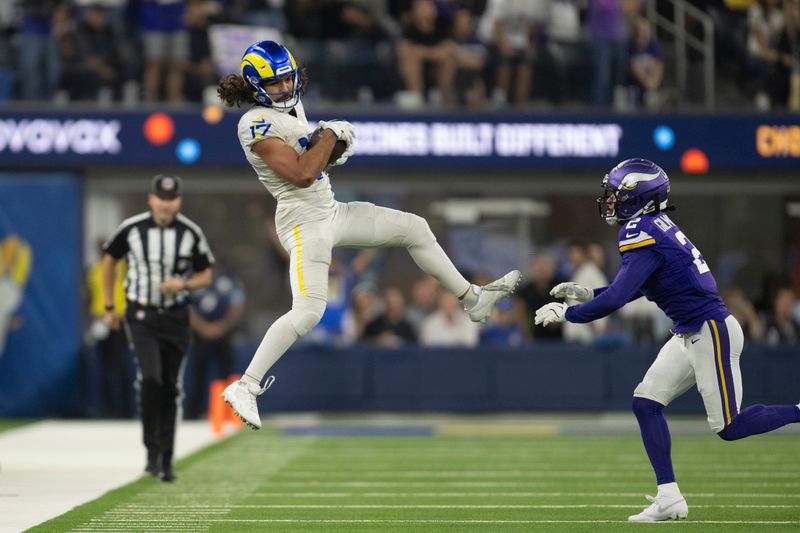 Los Angeles Rams wide receiver Puka Nacua (17) catches the ball over Minnesota Vikings cornerback Stephon Gilmore (2) during an NFL football game, Thursday, Oct. 24, 2024, in Inglewood, Calif. (AP Photo/Kyusung Gong)