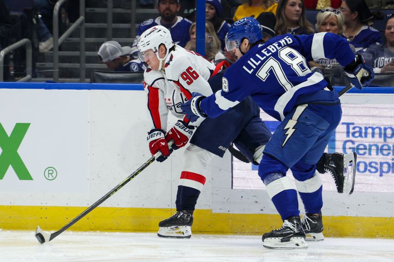 Feb 22, 2024; Tampa, Florida, USA;  Washington Capitals right wing Nicolas Aube-Kubel (96) controls the puck  from Tampa Bay Lightning defenseman Emil Martinsen Lilleberg (78) in the second period at Amalie Arena. Mandatory Credit: Nathan Ray Seebeck-USA TODAY Sports