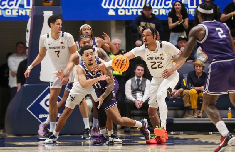 Mar 6, 2024; Morgantown, West Virginia, USA; TCU Horned Frogs guard Micah Peavy (0) passes the ball while defended by many West Virginia Mountaineers players during the second half at WVU Coliseum. Mandatory Credit: Ben Queen-USA TODAY Sports