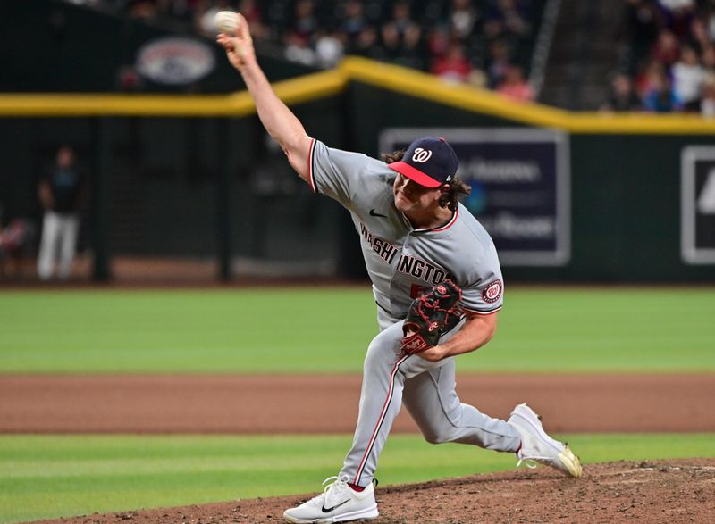 Jul 29, 2024; Phoenix, Arizona, USA;  Washington Nationals pitcher Kyle Finnegan (67) throws in the ninth inning against the Arizona Diamondbacks
 at Chase Field. Mandatory Credit: Matt Kartozian-USA TODAY Sports