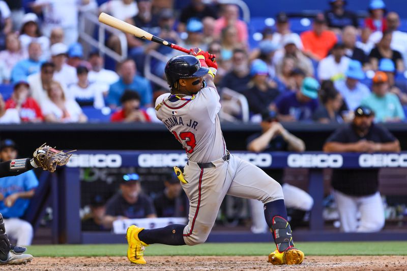 Apr 14, 2024; Miami, Florida, USA; Atlanta Braves right fielder Ronald Acuna Jr. (13) hits a single against the Miami Marlins during the ninth inning at loanDepot Park. Mandatory Credit: Sam Navarro-USA TODAY Sports