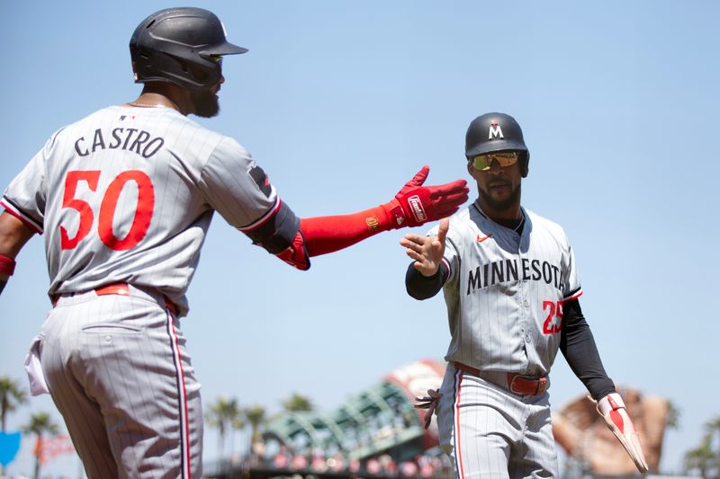 Jul 14, 2024; San Francisco, California, USA; Minnesota Twins shortstop Willi Castro (50) and pinch runner Byron Buxton (25) celebrate after scoring on a double by Manuel Margot (not pictured) during the ninth inning against the San Francisco Giants at Oracle Park. Mandatory Credit: D. Ross Cameron-USA TODAY Sports